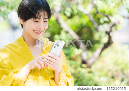 A woman operating a smartphone. 115219035