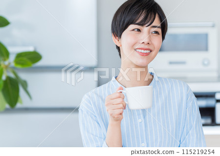 A woman relaxing in the living room. 115219254