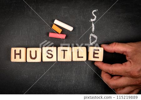 SIDE HUSTLE. Wooden block crossword puzzle and pieces of chalk on a chalkboard background SIDE HUSTLE. Wooden block crossword puzzle and pieces of chalk on a chalkboard background 115219889