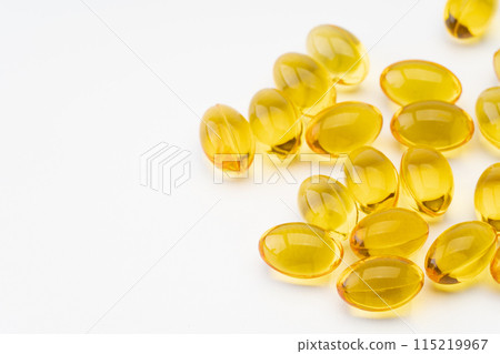 Yellow vitamin supplements close-up 115219967