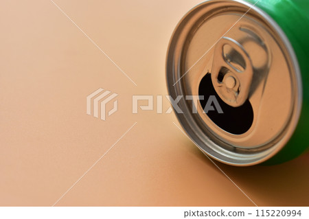 aluminum green drink cans on orange background, open cold fresh beverage aluminum green drink cans on orange background, open cold fresh beverage 115220994