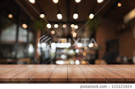 Empty wooden table top with lights bokeh on blur restaurant background. Empty wooden table top with lights bokeh on blur restaurant background. 115221924