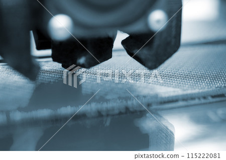 3D printer close up. Working 3D printer close-up. The process of printing on a 3D printer. 3D printer creating an object from molten plastic. 3D printer close up. Working 3D printer close-up. The process of printing on a 3D printer. 3D printer creating an object from molten plastic. 115222081