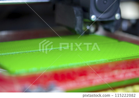 3D printer close up. Working 3D printer close-up. The process of printing on a 3D printer. 3D printer creating an object from molten plastic 3D printer close up. Working 3D printer close-up. The process of printing on a 3D printer. 3D printer creating an object from molten plastic 115222082