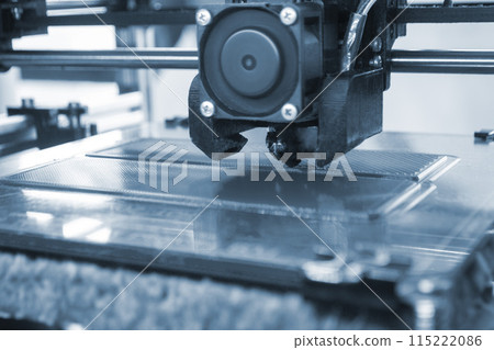3D printer close up. Working 3D printer close-up. The process of printing on a 3D printer. 3D printer creating an object from molten plastic. 3D printer close up. Working 3D printer close-up. The process of printing on a 3D printer. 3D printer creating an object from molten plastic. 115222086