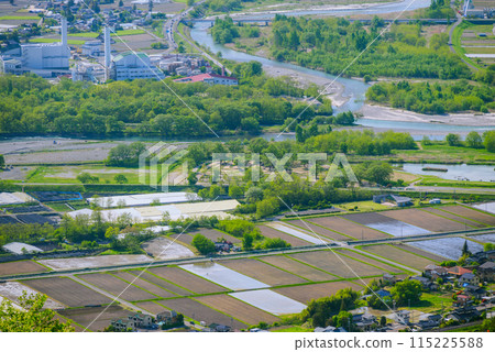 Fresh greenery and rice paddies beginning to fill with water [Photo taken from Mt. Nagamine, Azumino City] 115225588