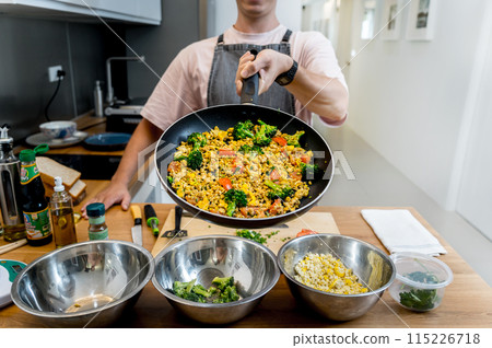 Chef at the kitchen preparing tofu scramble with vegetables Chef at the kitchen preparing tofu scramble with vegetables 115226718