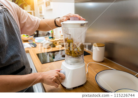 Chef at the kitchen preparing chickpea porridge with ginger 115226744
