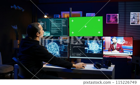 Hacker using green screen monitor and artificial intelligence to write spyware software gathering data from users. Scammer in apartment using AI and mockup PC display to do fraud using AI, camera B Hacker using green screen monitor and artificial intelligence to write spyware software gathering data from users. Scammer in apartment using AI and mockup PC display to do fraud using AI, camera B 115226749
