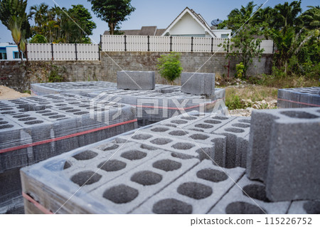 Concrete blocks with holes stacked on top of each other 115226752