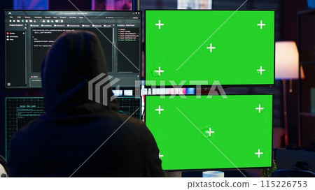 Dangerous man hacking using isolated screen PC, stealing credit card information and breaching banking systems. Hacker running code in apartment on chroma key computer display, close up, camera A 115226753