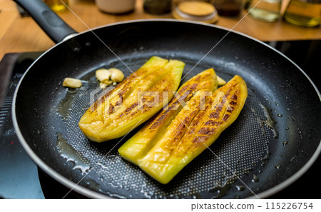 Delicious grilled eggplants with garlic on the fried pan 115226754