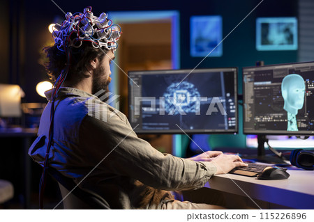 Developer with EEG headset on programming brain transfer into computer virtual world, becoming one with AI. Transhumanist using neuroscientific tech to transcend physical limitations 115226896