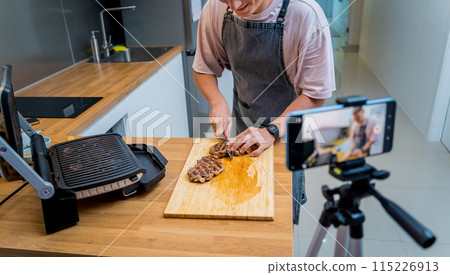 The chef is broadcasting live from workshop how to prepare a beef steaks on the electric grill 115226913
