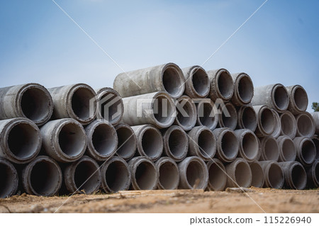 A stack of concrete ring pipes piled and creating a symmetrical arrangement A stack of concrete ring pipes piled and creating a symmetrical arrangement 115226940