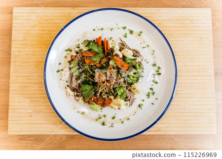 Japanese buckwheat pasta with lentils and vegetables in a bowl 115226969