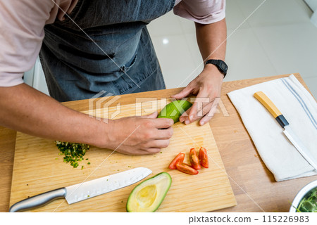 Chef at the kitchen preparing healthy quinoa bowl with avocado Chef at the kitchen preparing healthy quinoa bowl with avocado 115226983