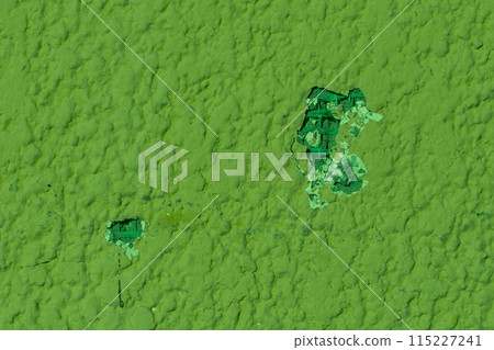 Broken damaged wall close-up hole on green plaster, repair concept Broken damaged wall close-up hole on green plaster, repair concept 115227241
