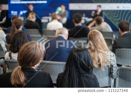 Audience attending a business seminar with speakers on stage Audience attending a business seminar with speakers on stage 115227348