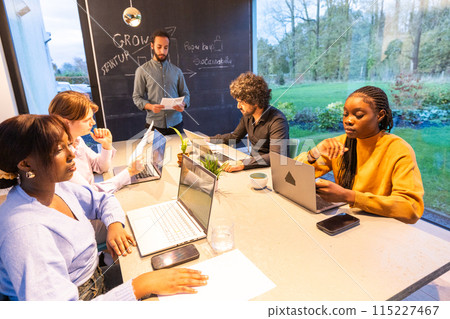 Professionals in a modern office meeting, discussing business strategies and innovative ideas 115227467