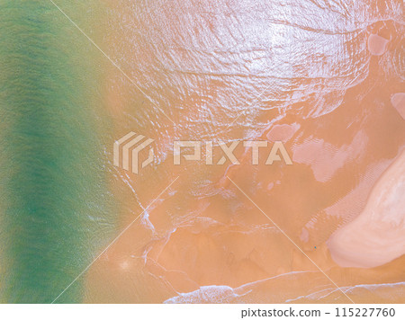 Aerial view of sea crashing waves White foaming waves on beach sand,Top view beach sea surface, Nature sea beach sand background 115227760