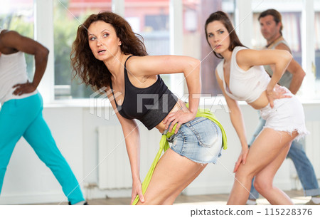 Fit and graceful woman partaking in high heels dance class 115228376