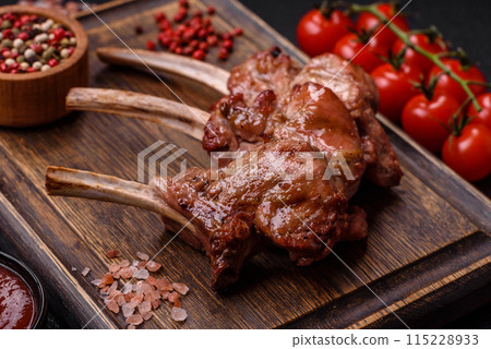 Delicious juicy meat on the bone or rack of lamb or grilled veal Delicious juicy meat on the bone or rack of lamb or grilled veal 115228933