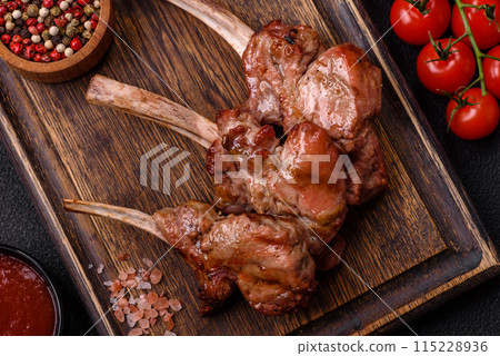 Delicious juicy meat on the bone or rack of lamb or grilled veal Delicious juicy meat on the bone or rack of lamb or grilled veal 115228936