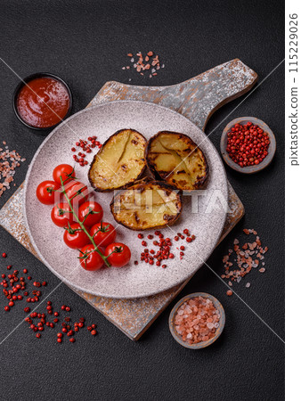 Delicious potato halves in skins baked on the grill 115229026