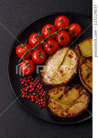 Delicious potato halves in skins baked on the grill 115229037