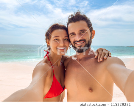 Happy Couple Taking Selfie on Tropical Beach Vacation 115229281