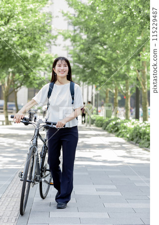 Commuting woman bicycle 115229487