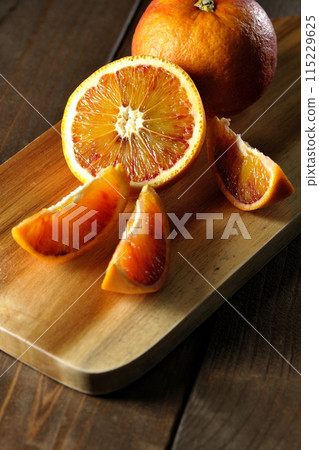 Blood oranges on a cutting board Blood oranges on a cutting board 115229625