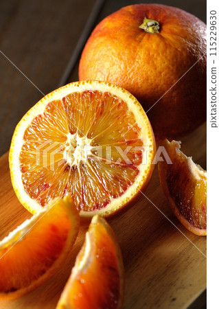 Blood oranges on a cutting board Blood oranges on a cutting board 115229630