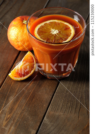 Blood orange juice with slices of fruit floating in it 115230000