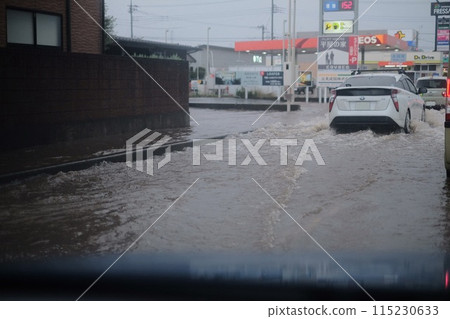 Cars moving through a flooded road after heavy rain Cars moving through a flooded road after heavy rain 115230633