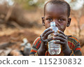 african child boy in Africa drinking clean water from plastic bottle 115230832