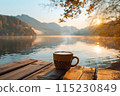 cup of hot coffee or tea with lake and mountains view on the background 115230849