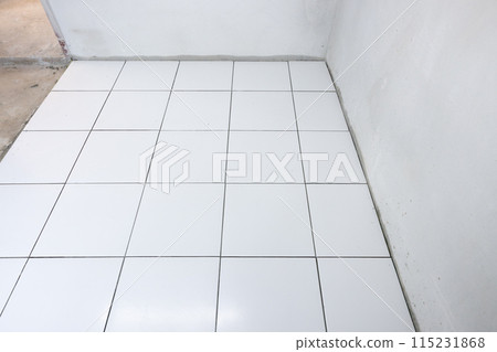 Tile floor under construction in room. 115231868