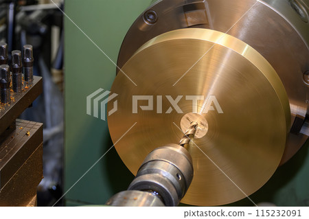 The hole drilling process on brass material parts by lathe machine. The hole drilling process on brass material parts by lathe machine. 115232091