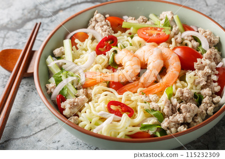 Yum Mama Instant Ramen Noodle Salad with meat, shrimp and vegetables closeup on the plate. Horizontal Yum Mama Instant Ramen Noodle Salad with meat, shrimp and vegetables closeup on the plate. Horizontal 115232309