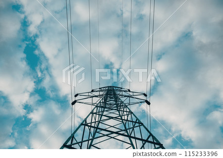 Electricity pylon with overhead powerline cables against cloudy sky 115233396