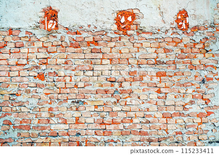 Texture of rough worn brick wall. Old facade as background. Urban patterns and details. 115233411