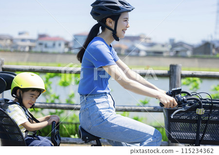 Parents riding a bicycle Parents riding a bicycle 115234362
