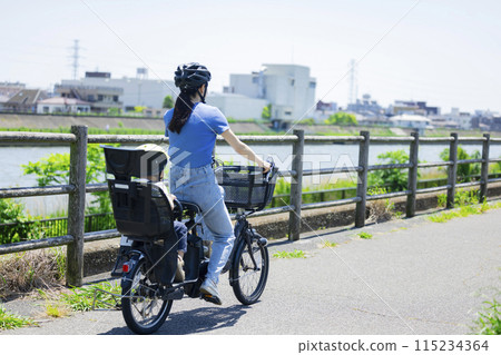 Parents riding a bicycle Parents riding a bicycle 115234364