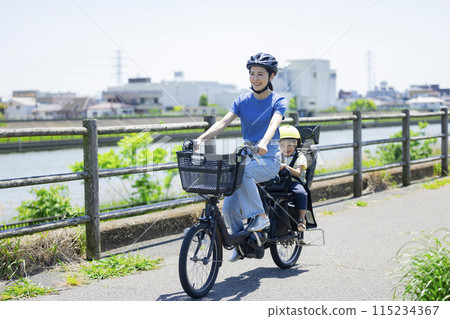 Parents riding a bicycle 115234367