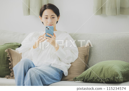 A woman watching a smartphone 115234574