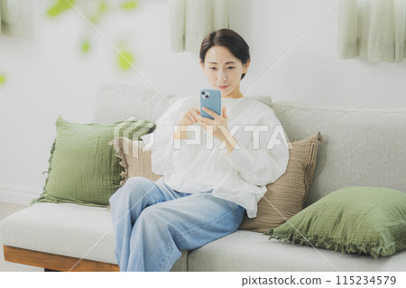 A woman watching a smartphone 115234579