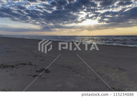 Panoramic picture over the beach of Ouddorp in Holland in the evening during sunset 115234886