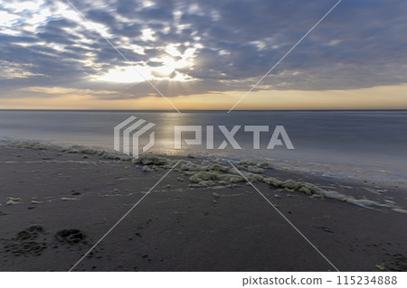 Panoramic picture over the beach of Ouddorp in Holland in the evening during sunset 115234888
